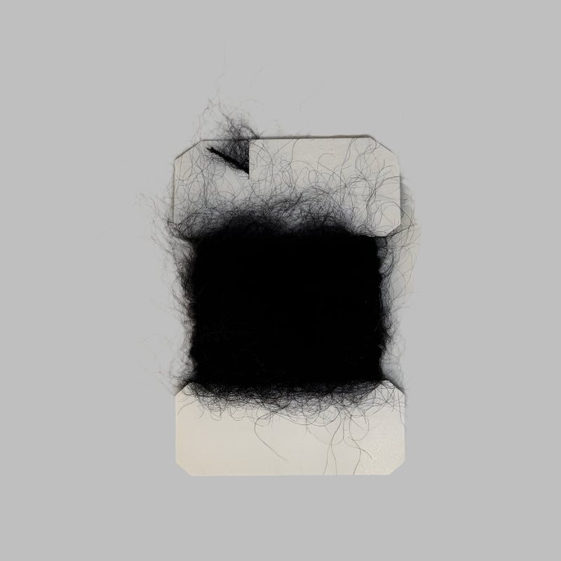 Leech mohair yarn tuft on card, black