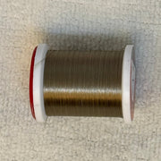 Spool of 70 denier thread in dark brown with red side flanges