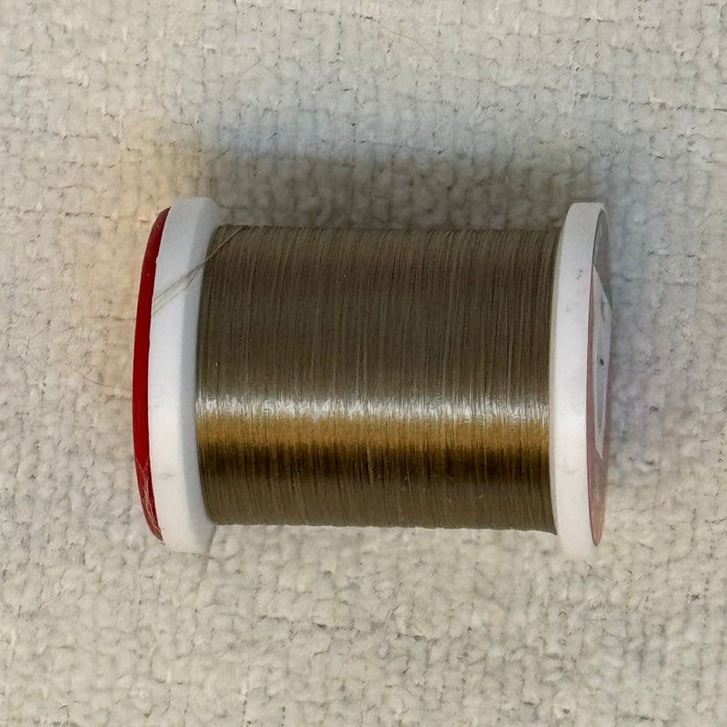 Spool of 70 denier thread in dark brown with red side flanges
