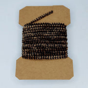 Medium variegated chenille yarn spool, dark brown and tan striped texture