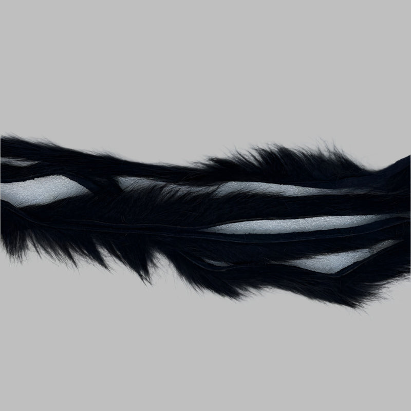 Zonker strips in black, long wavy fur strip with dark underfur visible