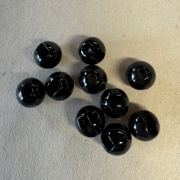 pile of ten black slotted tungsten beads