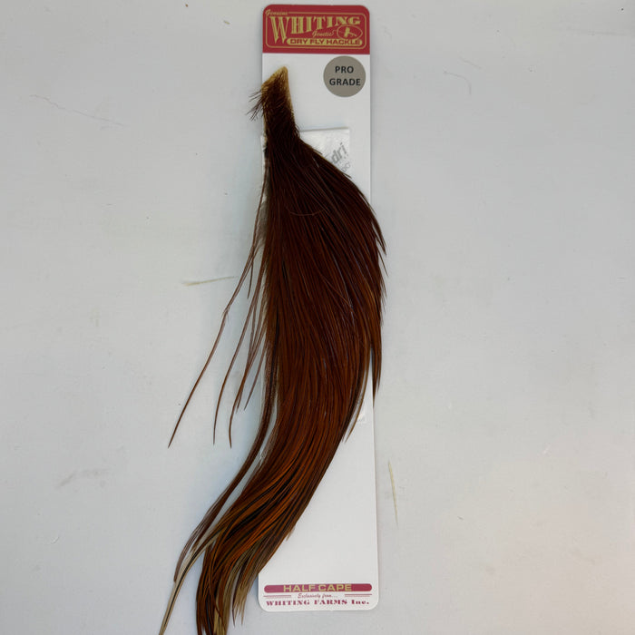 Brown half cape of feathers on packaging