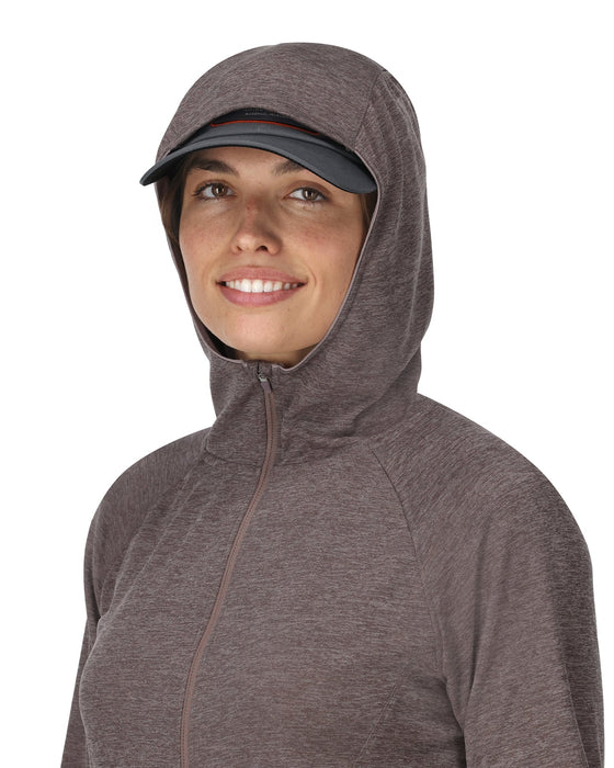 Woman wearing a brownish hooded jacket on a white background