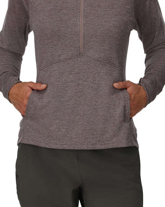 Person wearing a pullover with a half zipper and black pants on a white background