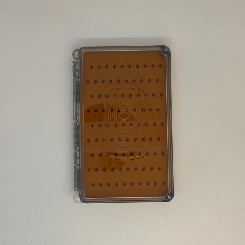 Fly box with closed clear lid and brown pattern, seen from above