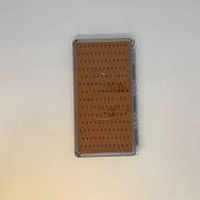 Closed fly box with orange-brown interior grid pattern