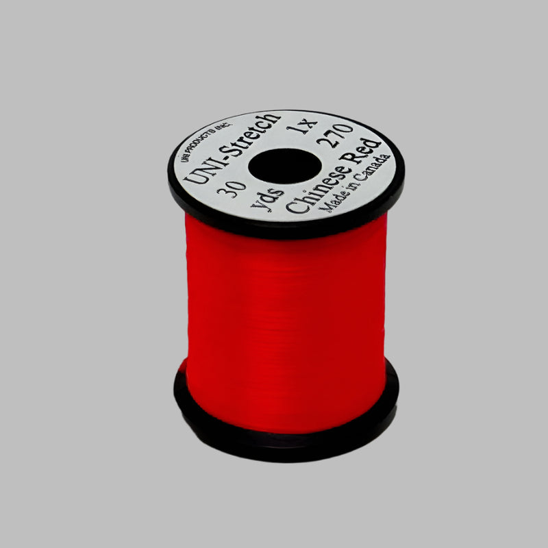 Red stretch thread spool with label on top, 30 yd