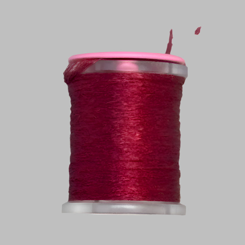 UTC Antron yarn spool in dark red on a clear bobbin with pink top ring