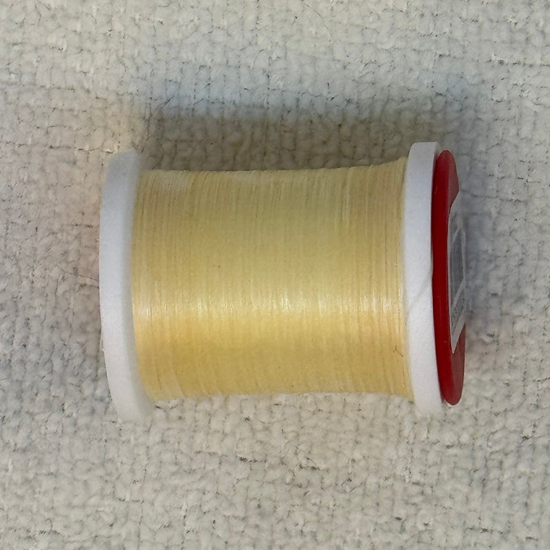 Spool of 70 denier thread in pale yellow with red side flanges