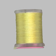 UTC Antron yarn spool in light yellow on a clear bobbin with pink top ring