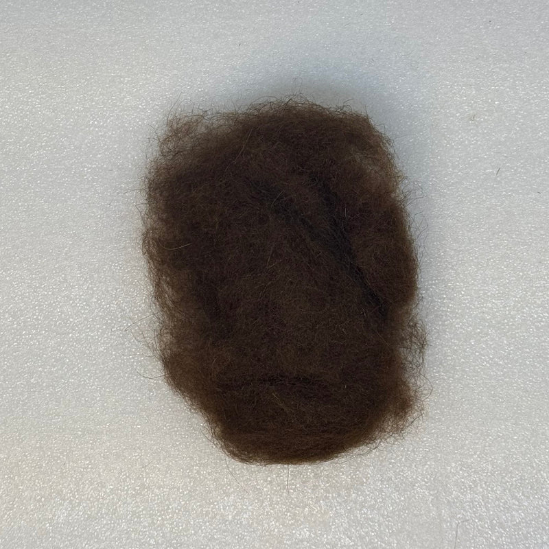 Dark brown dubbing fibers clump