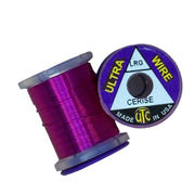 Ultra Wire spool with cerise wire wound around a clear plastic holder.