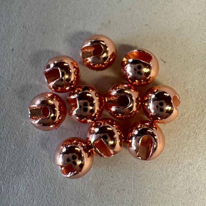 Pile of ten copper colored slotted beads