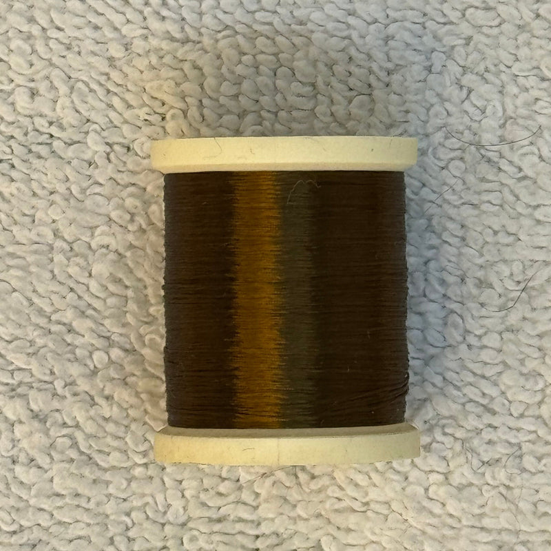 Four-strand floss spool with dark brown thread and light olive sheen