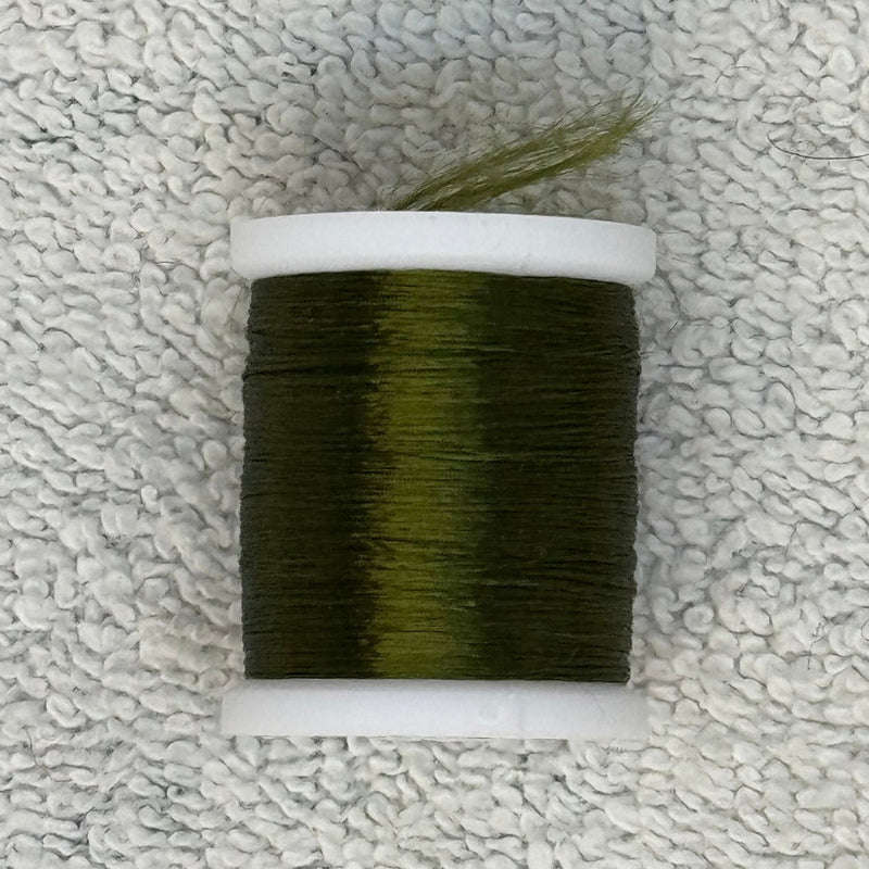 Four-strand floss spool with dark olive green thread on a cream core