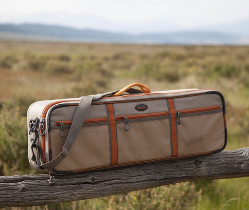 a picture of the Dakota Carry-on rod and reel case sitting on a split rail fence in a meadow
