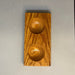 a small wooden square with two round depressions used by fly tyers to hold beads, hooks, and other small items