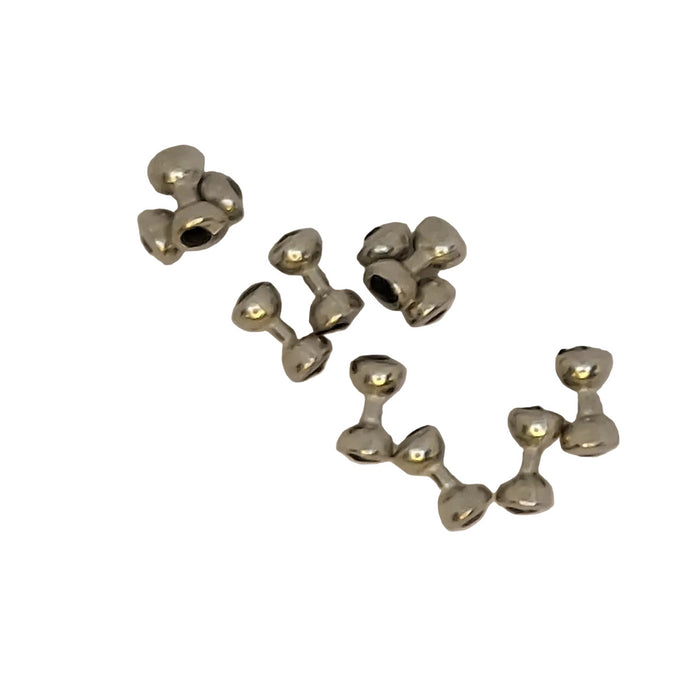 Small silver dumbell shaped "eyes" for fly tying on a white background