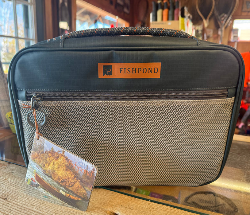 Fishpond fly tying kit case with zip closure, front mesh pocket, and attached tag