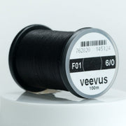 Black 6/0 sewing thread spool, veevus brand label on round bobbin