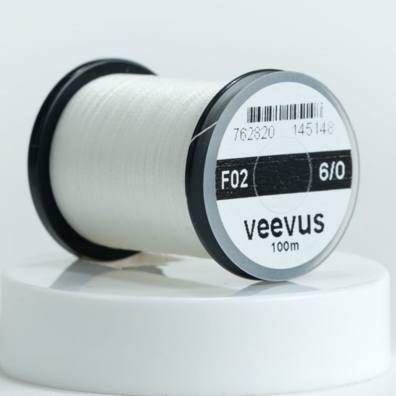 White 6/0 sewing thread spool, veevus brand label on round bobbin