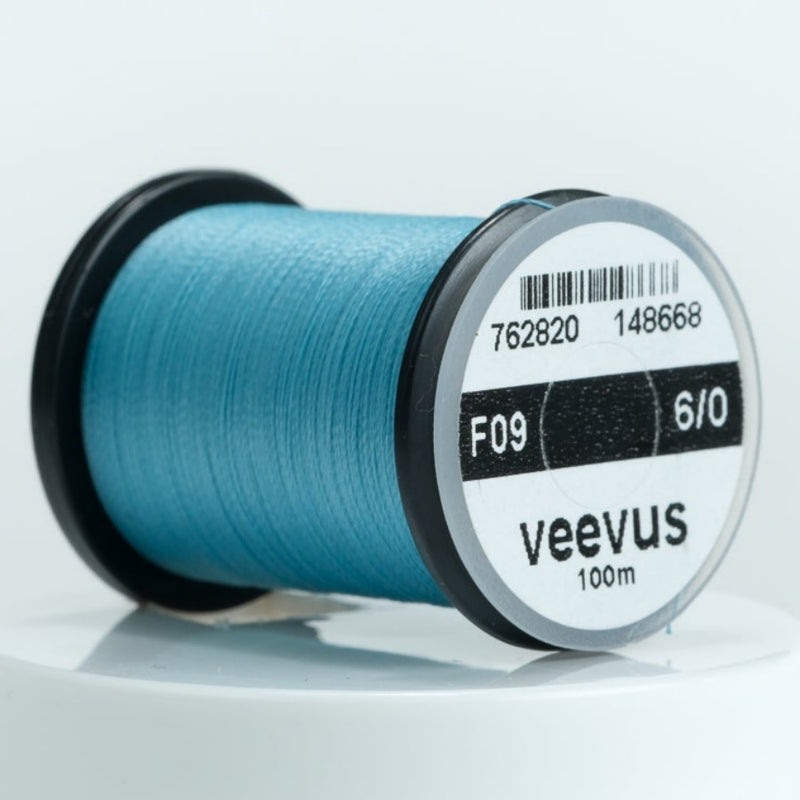 Blue 6/0 sewing thread spool, veevus brand label on round bobbin