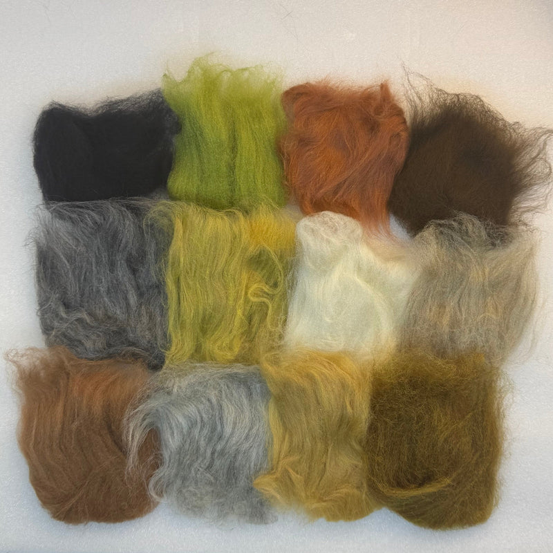 Fly-tying dubbing fibers assortment in dark, olive, orange, gray, and cream colors