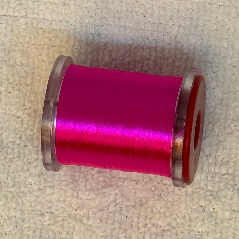 70 denier thread spool in magenta with a shiny finish