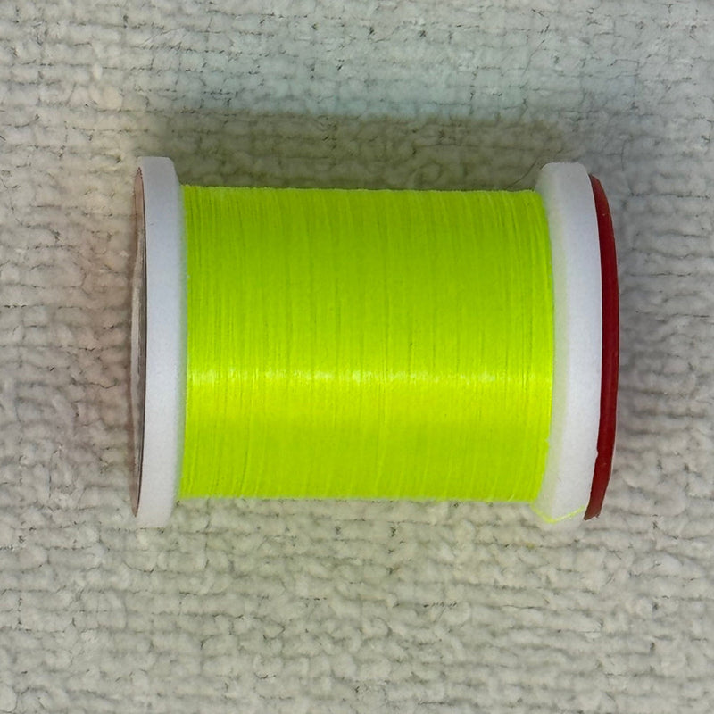 Spool of 70 denier thread in neon green with red side flanges