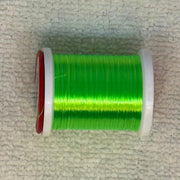Spool of 70 denier thread in vivid green with red side flanges