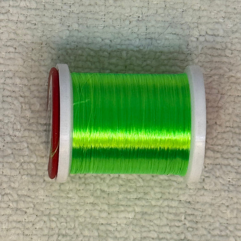 Spool of 70 denier thread in vivid green with red side flanges