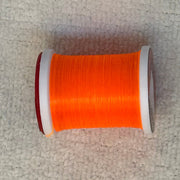 70 denier thread spool in bright orange with metallic sheen