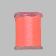 UTC Antron yarn spool in coral red on a clear bobbin with pink top ring
