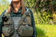 Fly fishing vest with taupe mesh, green trim, front zip pockets, and adjustable shoulder straps