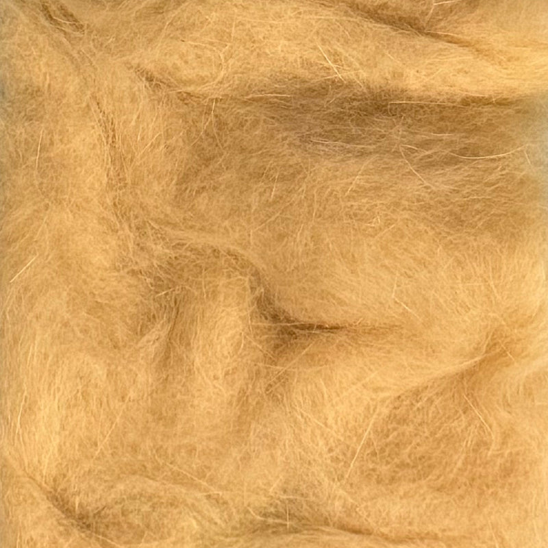 Rabbit dubbing material in light tan, soft shaggy fibers.