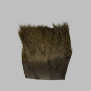 Dark brown deer hair patch with short dense fibers and trimmed base