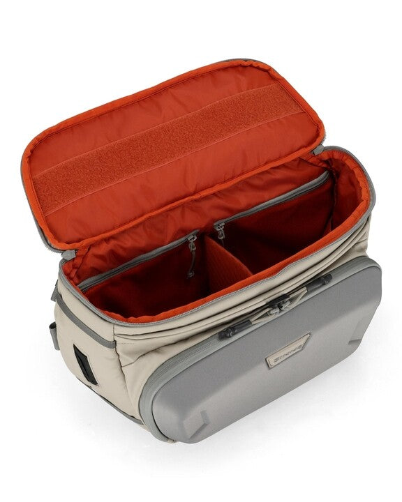 Simms sling pack opened, red interior with beige shell and gray trim
