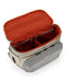 Dolomite colored sling pack with top open and orangish/red interior