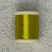 Four-strand floss spool with chartreuse yellow-green thread on a white core
