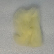 Pale yellow fly tying dubbing fibers clump, soft and fluffy