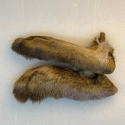 Paired hare-fur feet with long tufted bodies in golden tan and darker brown