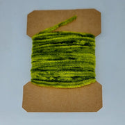 Medium rayon chenille yarn spool in light olive green with ribbed fuzzy texture