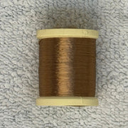 Four-strand floss spool with medium brown thread on a cream core