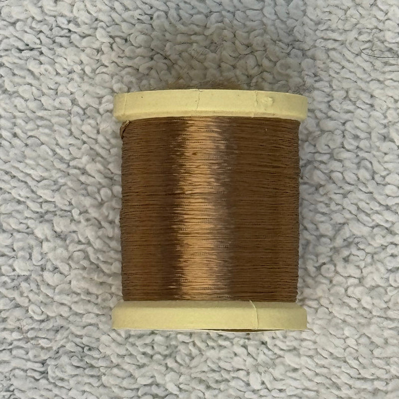 Four-strand floss spool with medium brown thread on a cream core