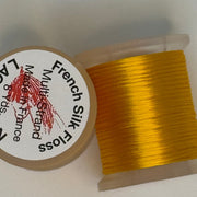 French silk floss spool with tightly wound golden yellow thread