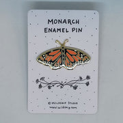 Monarch enamel pin featuring a colorful butterfly design on a backing card.