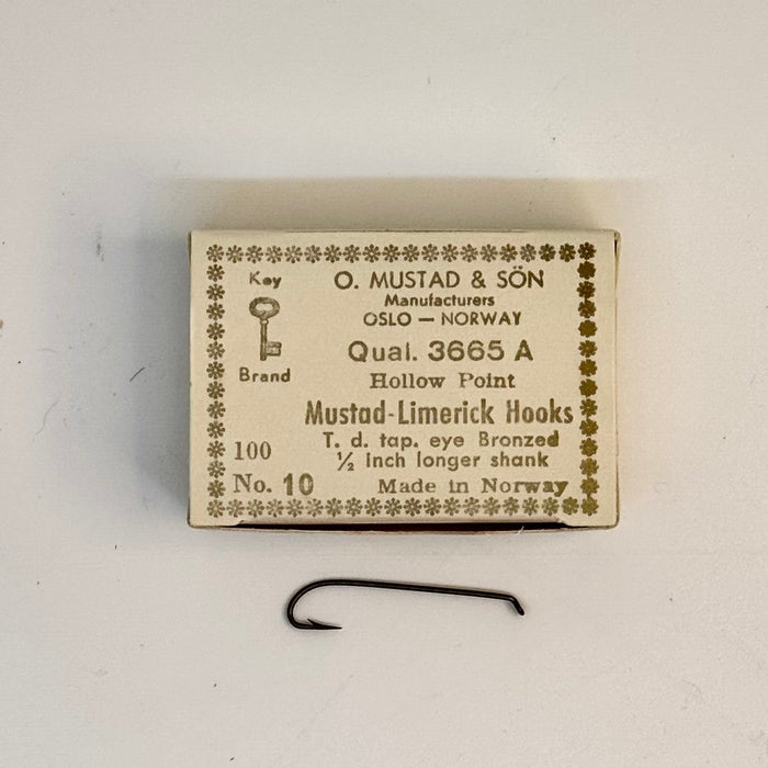 Size 10 box of Mustad hook with one hook below the box