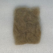 Olive-brown dubbing fibers clump