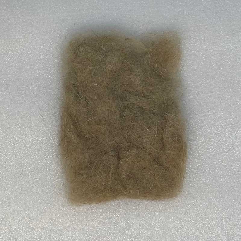 Olive-brown dubbing fibers clump
